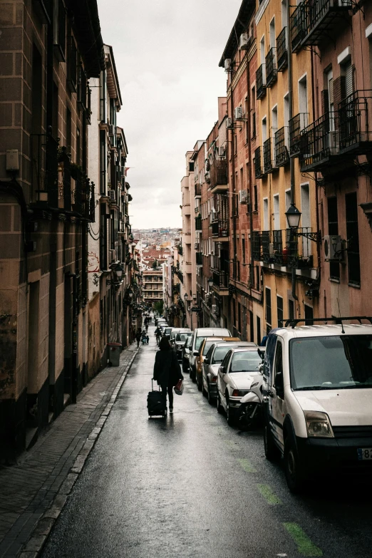 people riding bikes on a city street near buildings