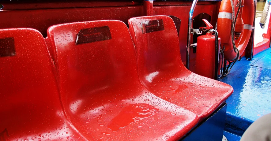 an empty seat on a red bus