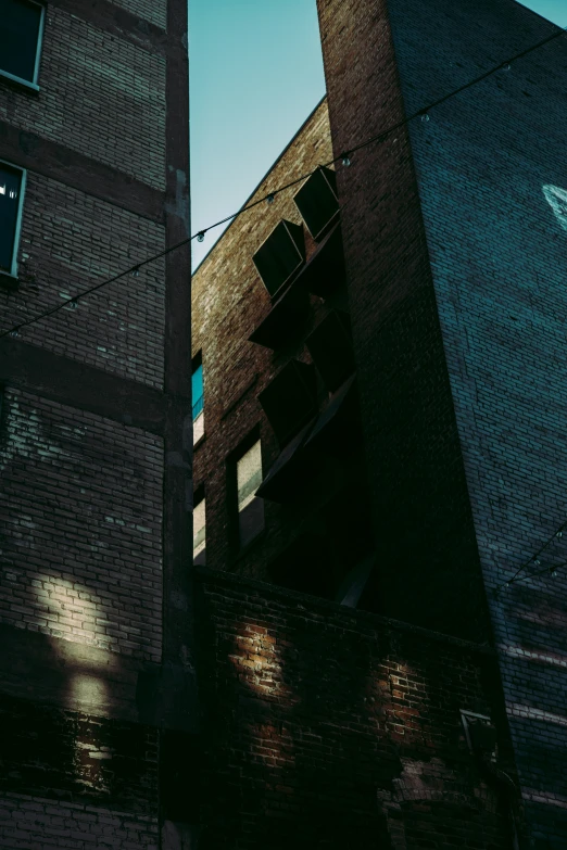 the view of two very tall buildings from below