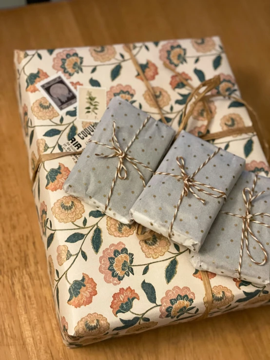 three wrapped present wrapped in blue and pink flowers