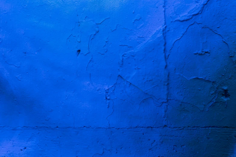 blue concrete wall with a red toilet in it