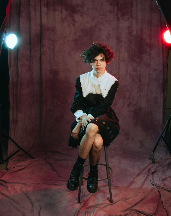 a woman wearing a black dress is posing for a pograph