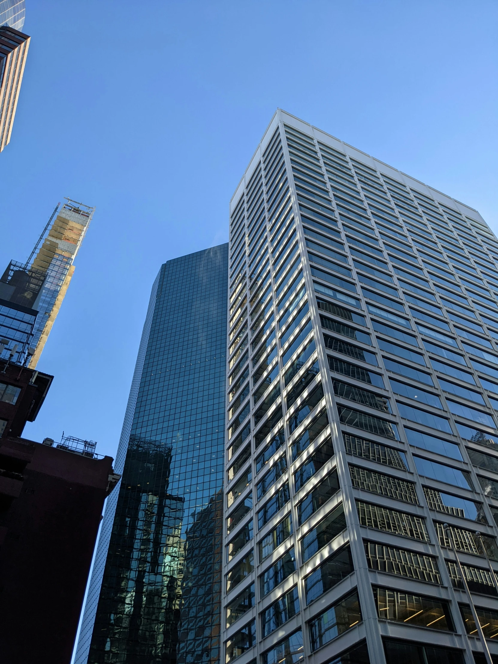 tall buildings are standing close to each other in a city