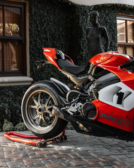 a red and white motorcycle parked in front of a building