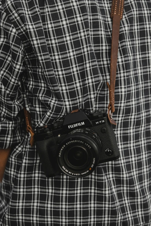 a man is holding his camera in a belt