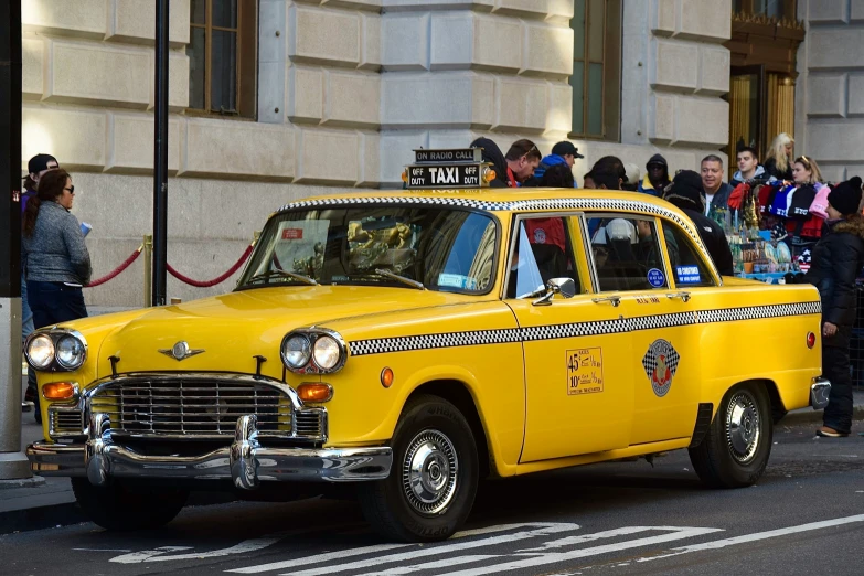 a yellow taxi cab that is parked on the street