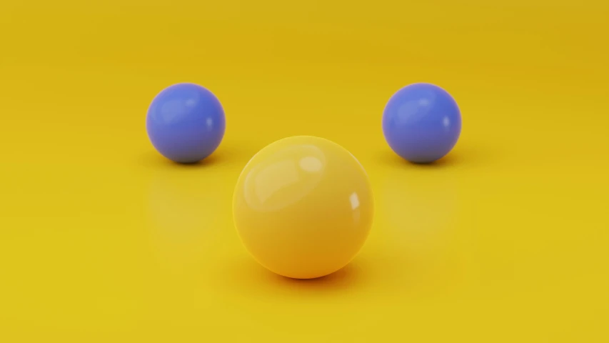 three balls are on a yellow surface
