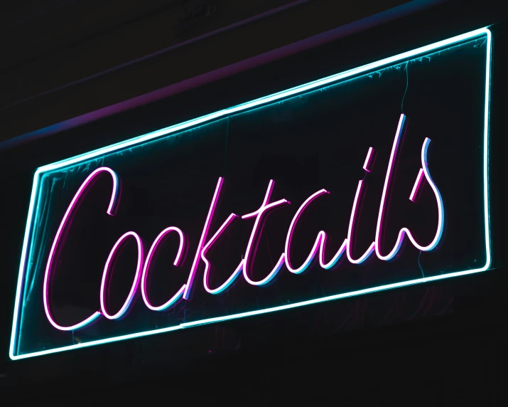 a neon sign with the word coca colas on it