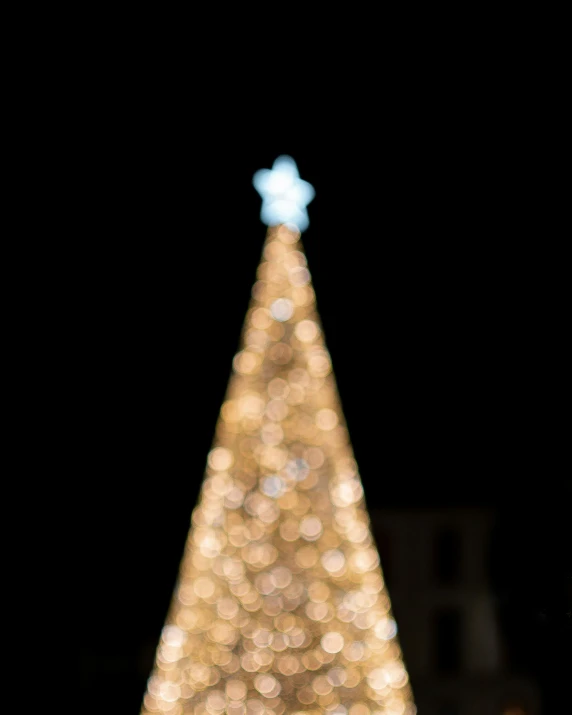 large white christmas tree with a blue cross on it