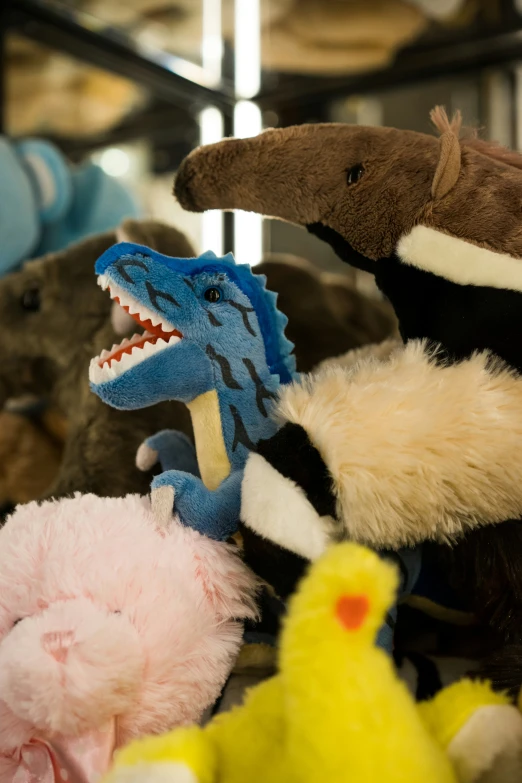 stuffed animals in display on shelves in the store