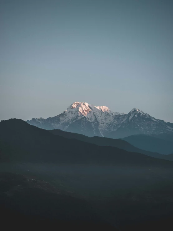 a mountain peak towering over the city in the sky