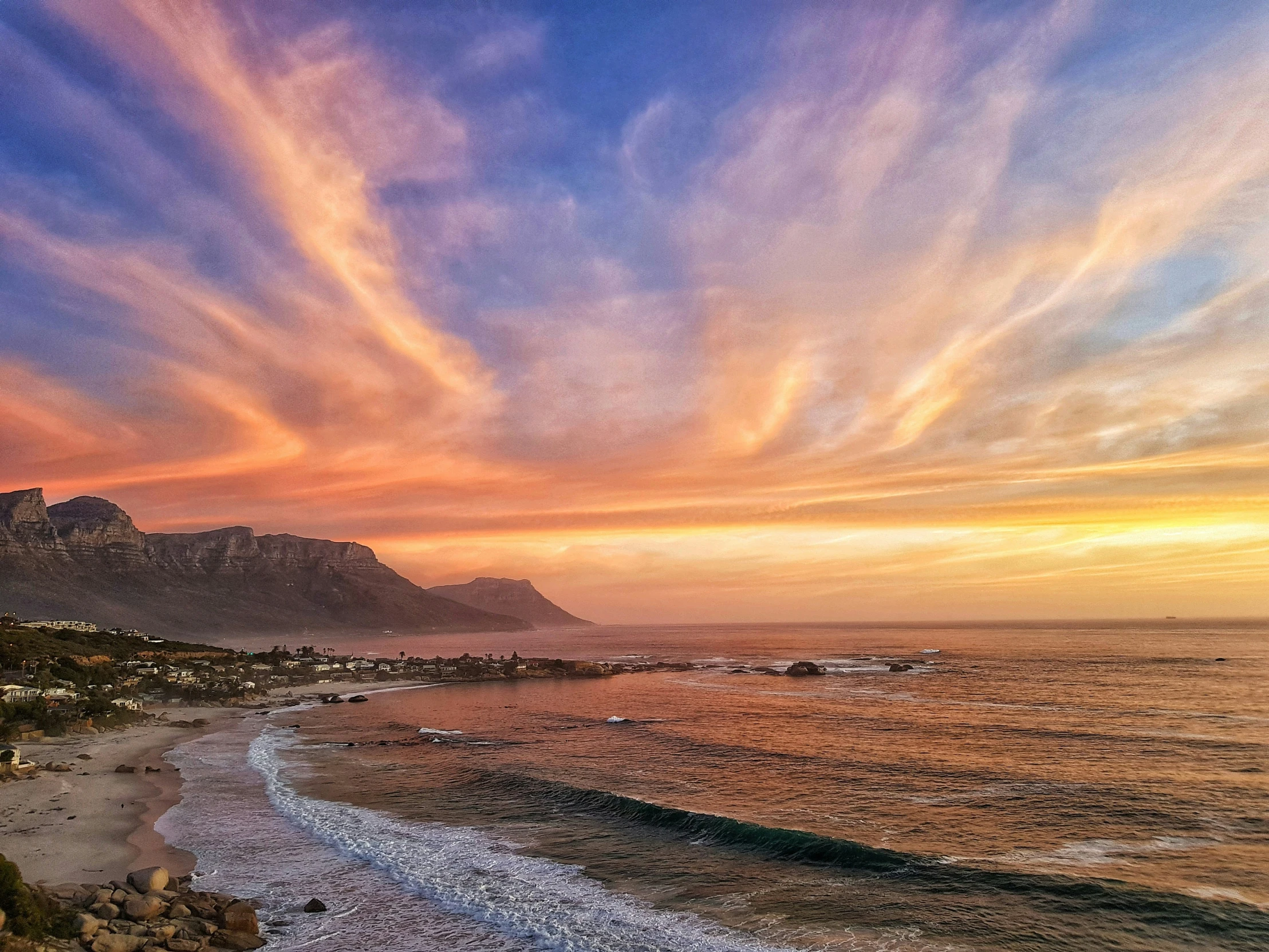 a beach is shown during a beautiful sunset