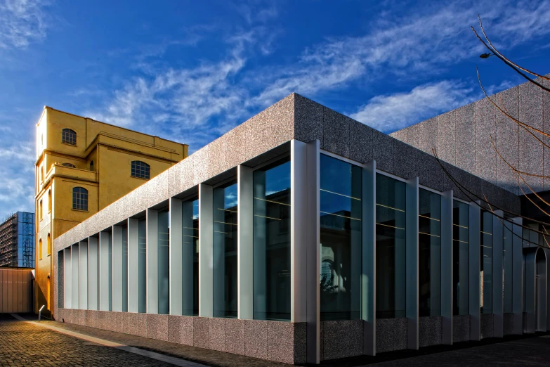 a building with many windows, and some sky in the background