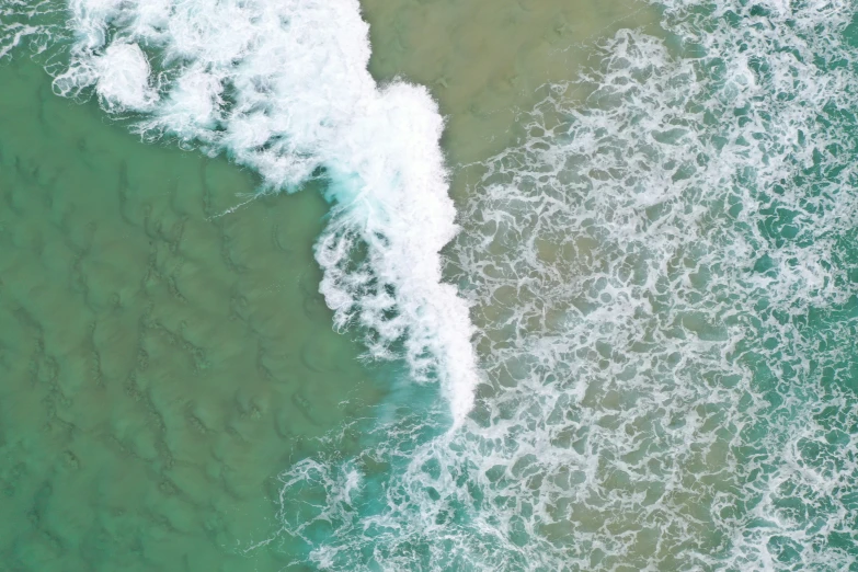 top view of the ocean with clear green waves