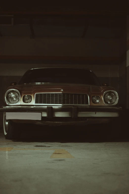 an old rusty car parked in the garage