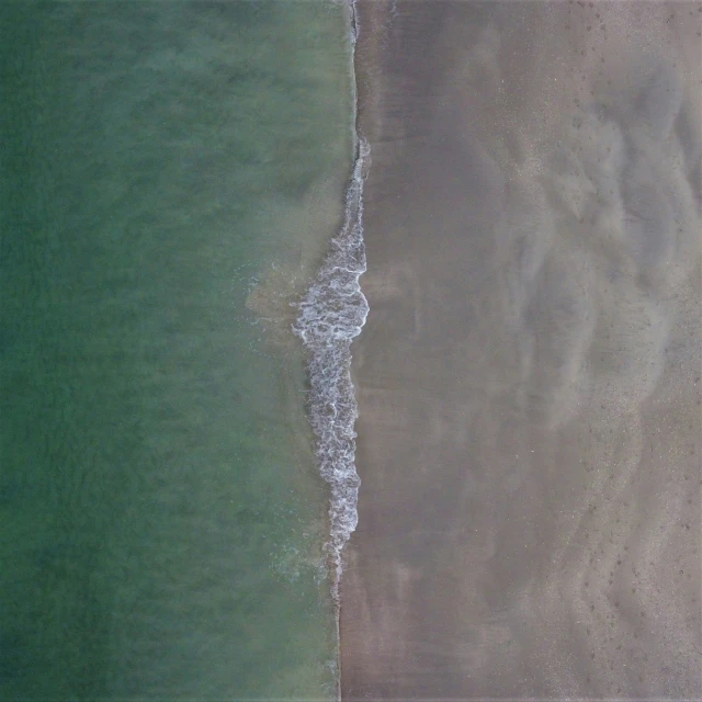 an aerial po of a beach, sea, and sky