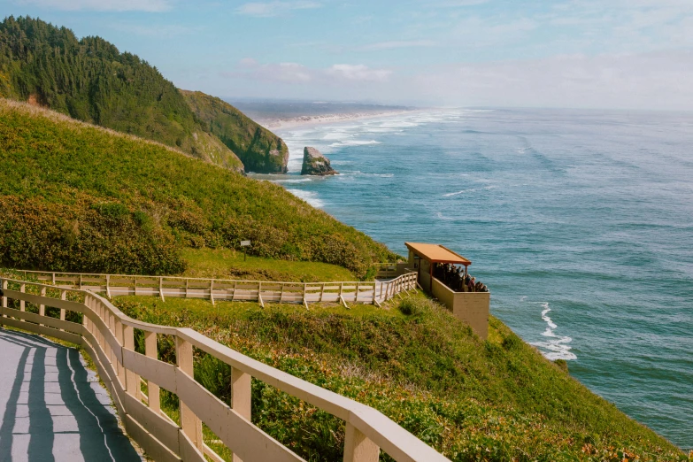 two long benches sitting on the side of a grassy hill