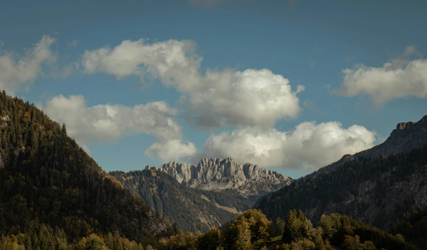 there is some mountains with clouds in the sky