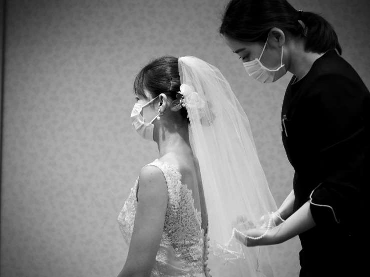 the bride is wearing her mask and ready to take off