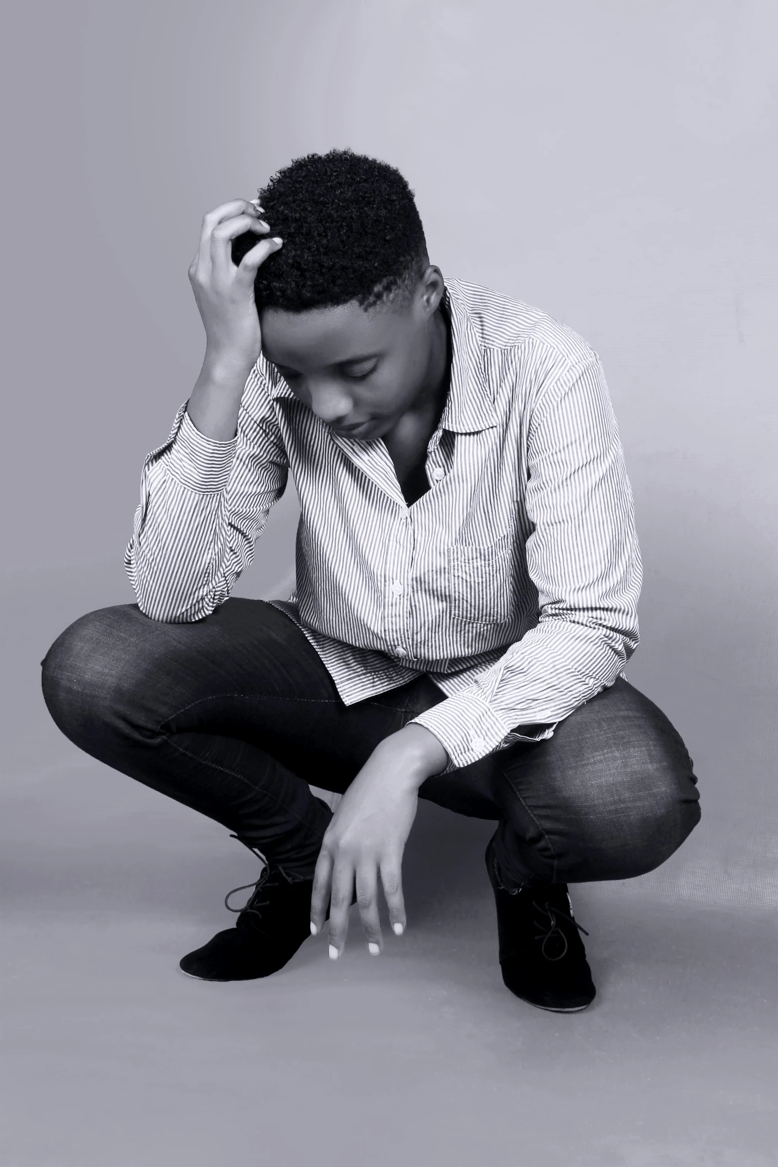 a man with dark hair sits on the ground