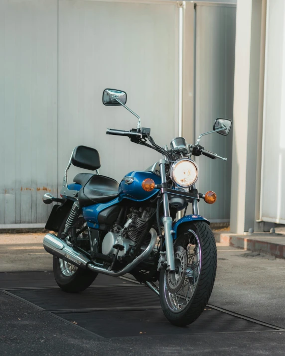 the motorcycle is parked next to a wall