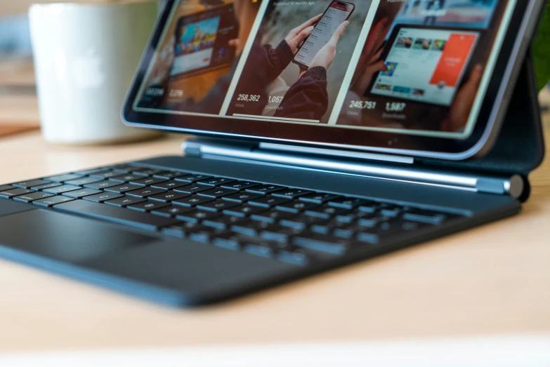 an open laptop computer sitting on top of a wooden table