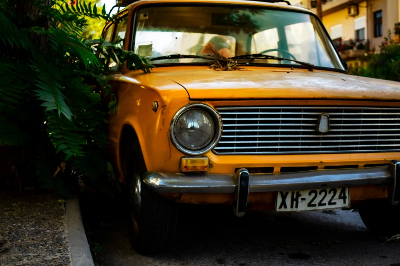 a very pretty looking old car parked in a driveway