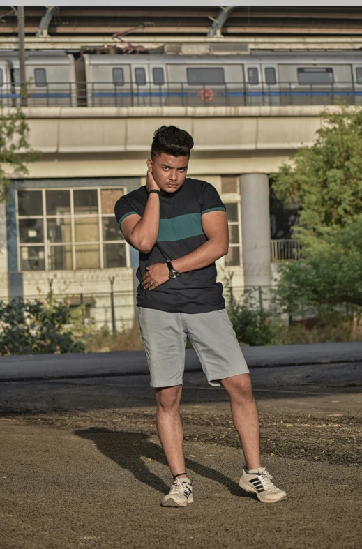 a man walking on the side of a road in front of a train