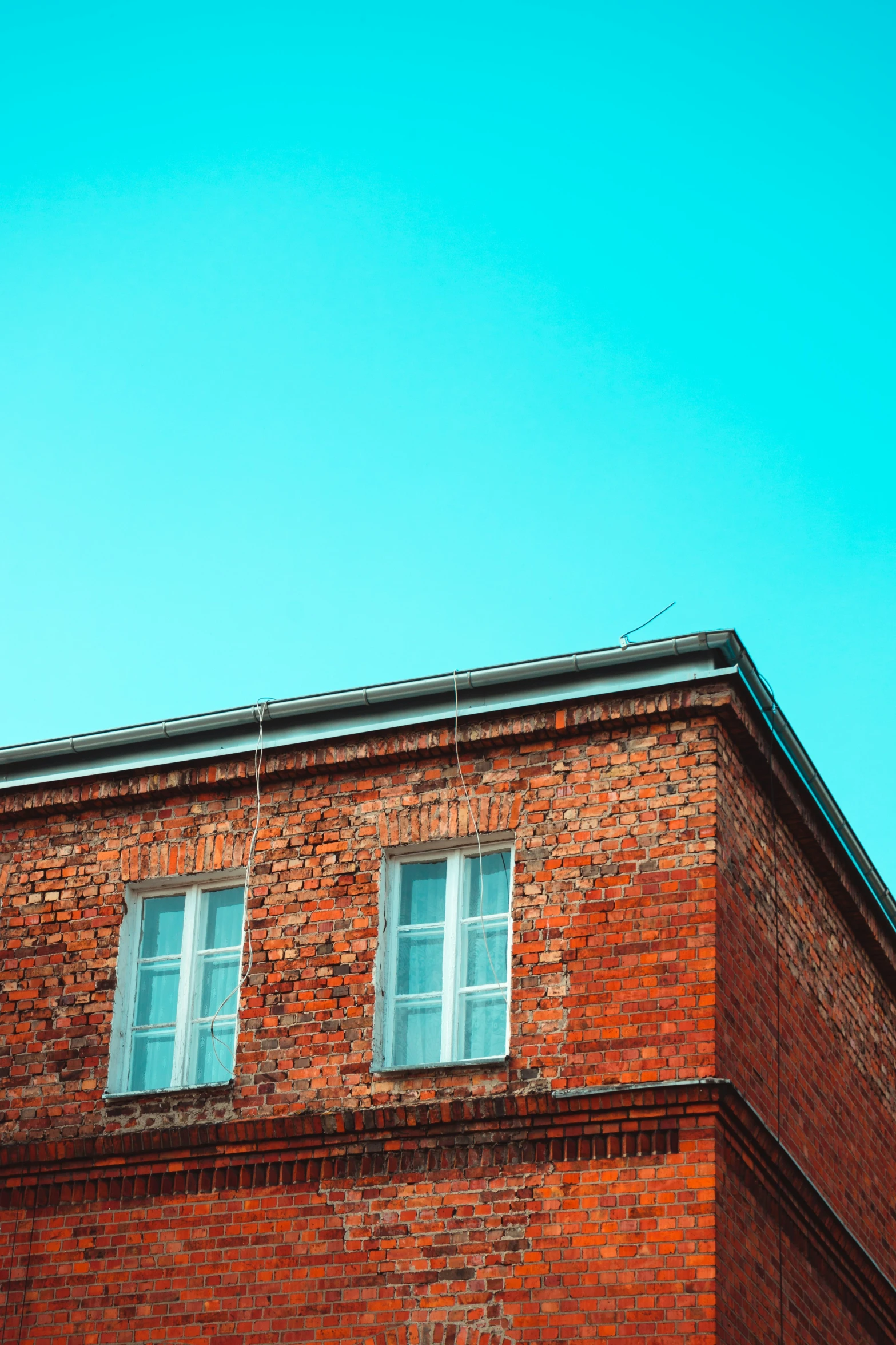 an old red brick building with two windows