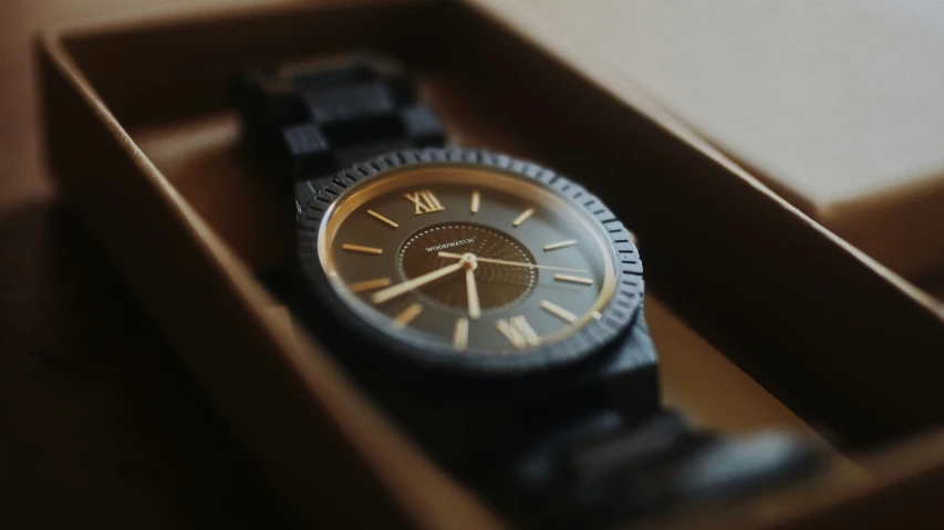 there is a watch that is in a wooden box