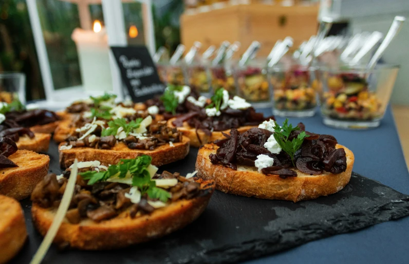 sandwiches with different toppings on a black platter