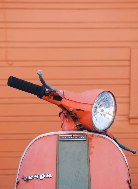 a close up of an old red scooter