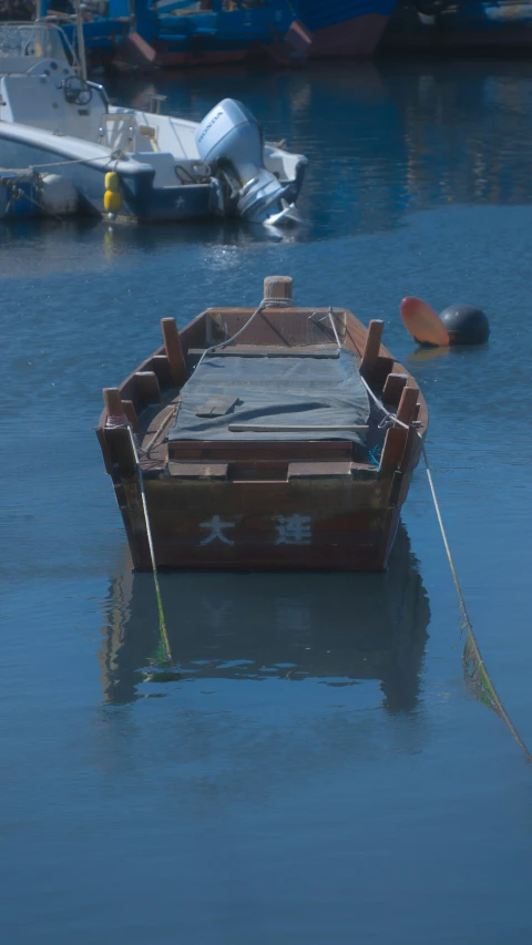 an old boat that has been docked is sitting in a harbor