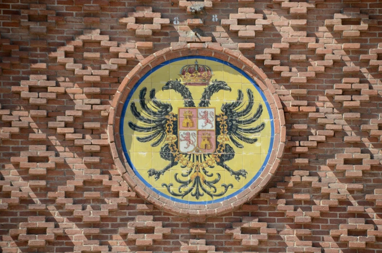 a circular window with a coat of arms on it