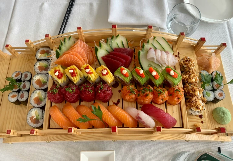 a tray is filled with a variety of sushi