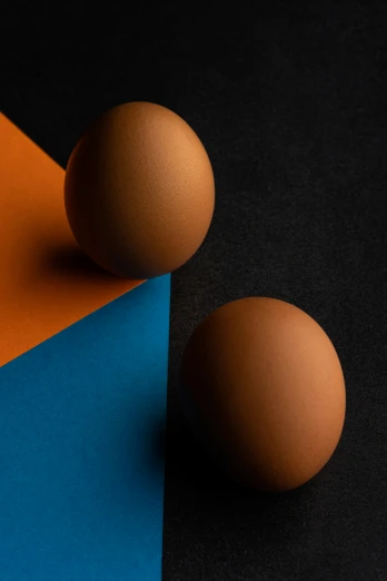 an egg and two balls lying next to each other