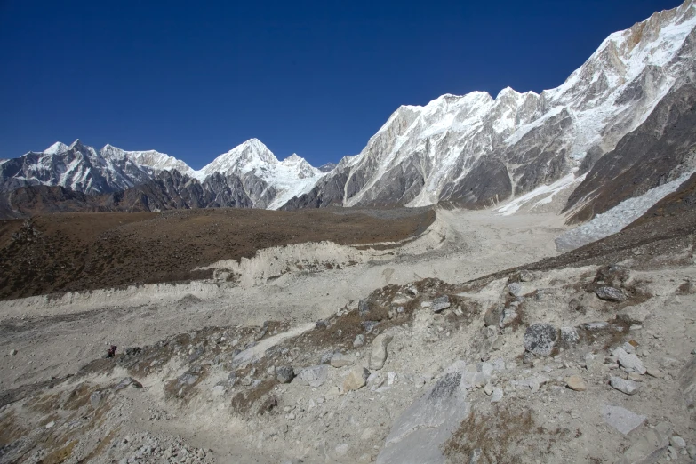 a view of mountains covered in snow and dirt