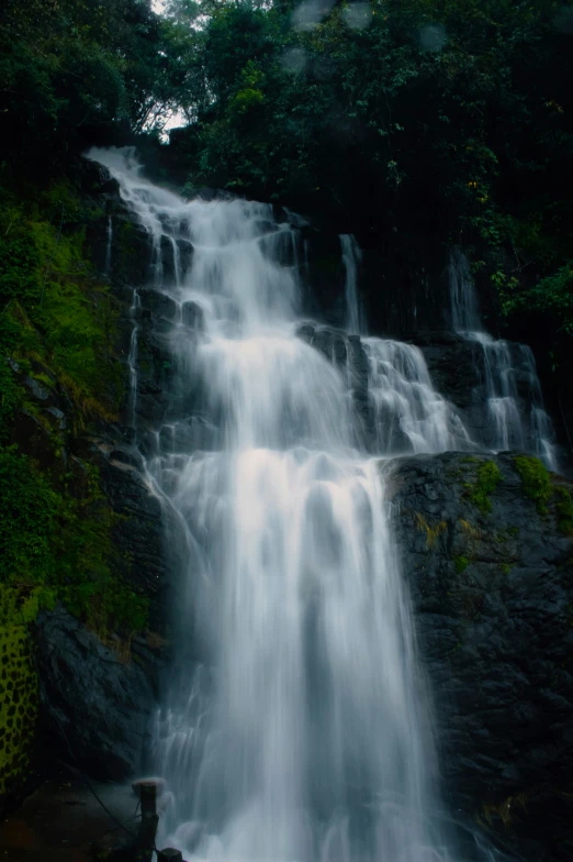 an empty waterfall with a wooden walkway underneath