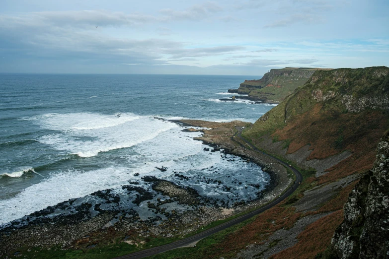 some ocean cliffs with a long stretch of water