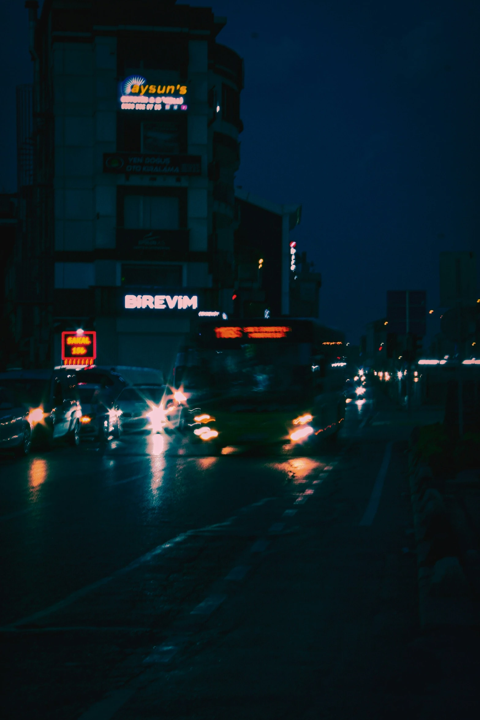 night time picture of cars driving on a busy street