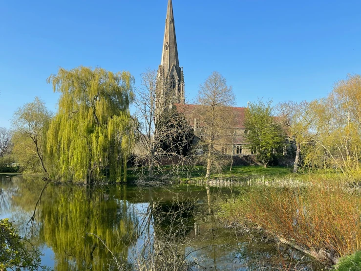 there is a very tall church next to the water