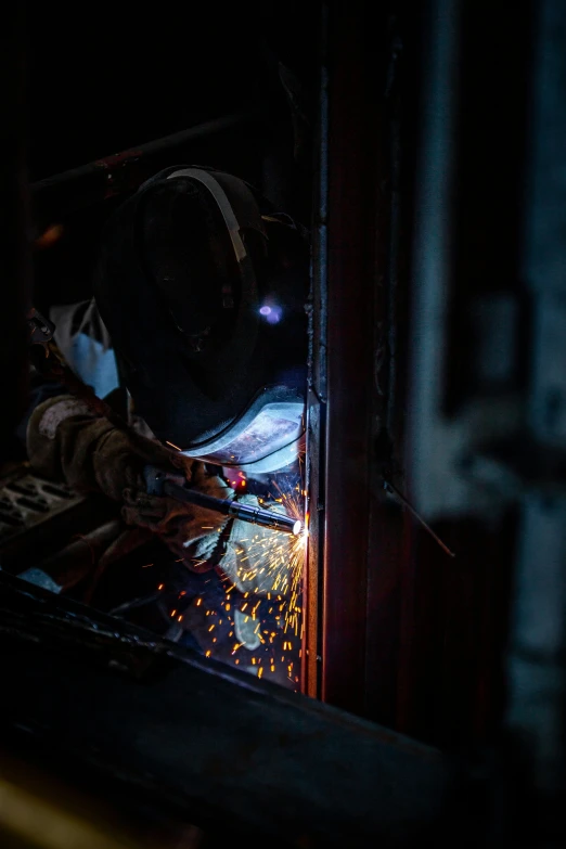 a welder working on some kind of metal