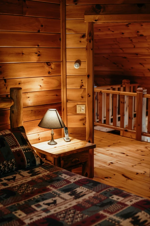 a bedroom with wood walls and wooden floors