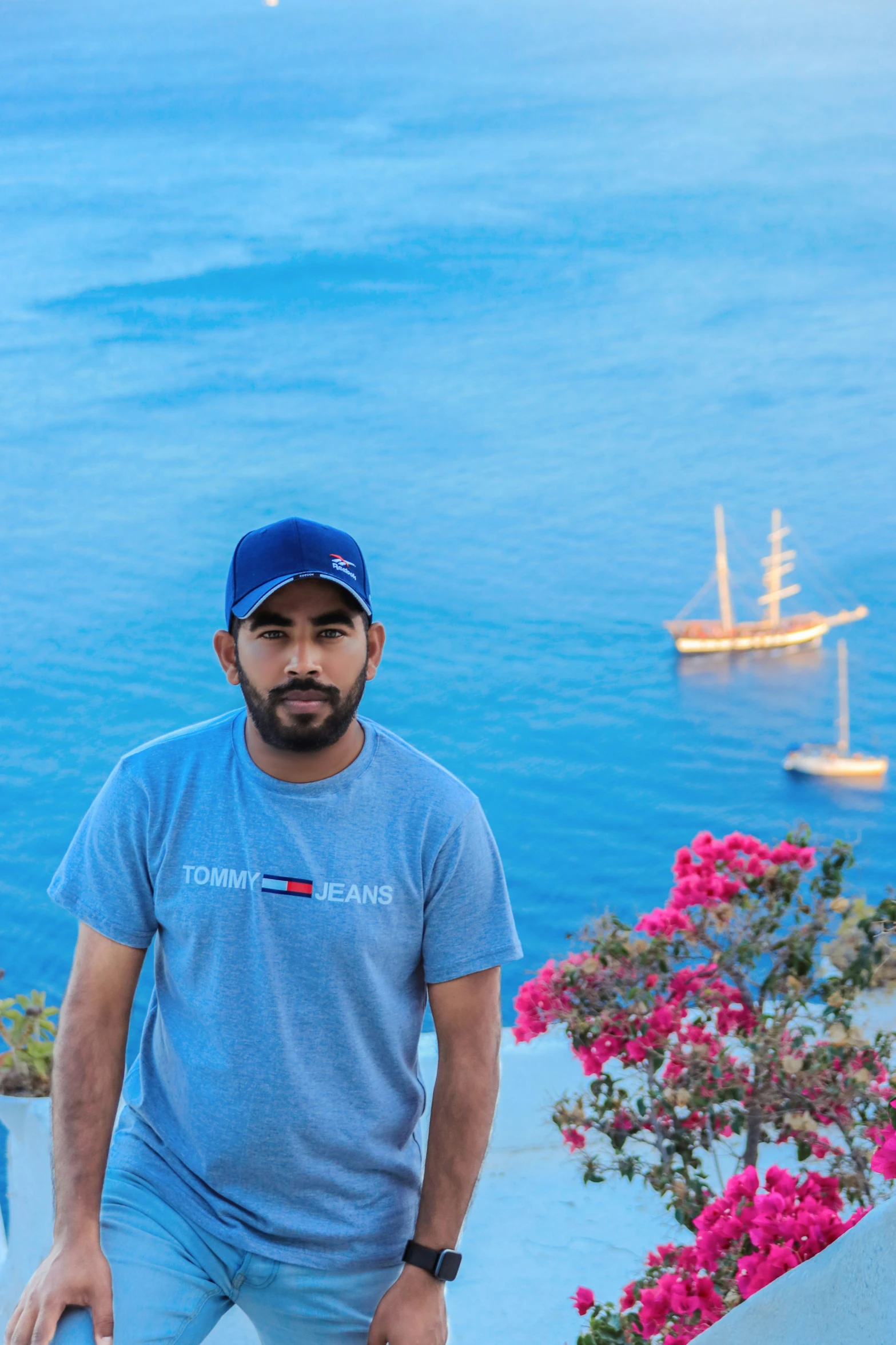 a man is taking a picture in front of the ocean