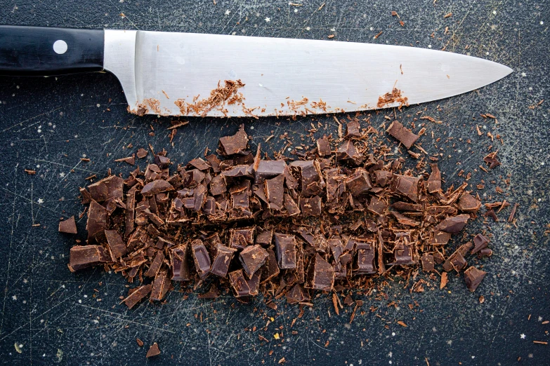 chocolate chunks and knife on the floor with spilled chocolate