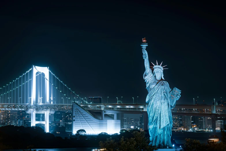 the statue of liberty is illuminated up in blue and white