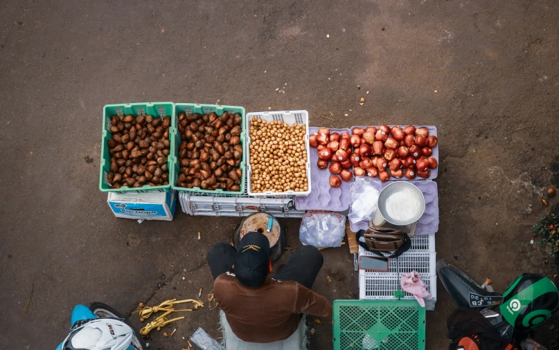 fruits and vegetables at a farmer's market with one person laying on the ground