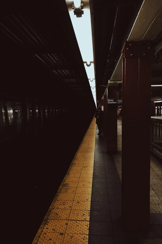 a subway station at night time with the light turned on