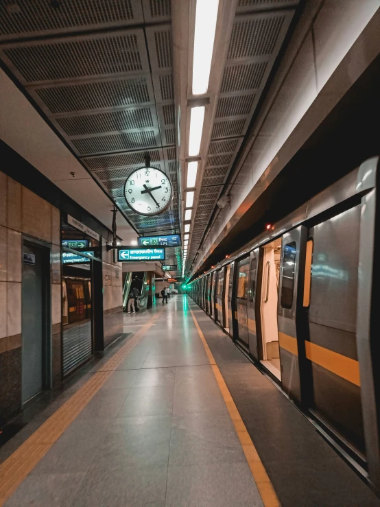 the inside of a train station with a clock displayed