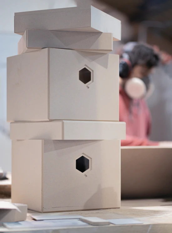 a close up of a small bird house on a table